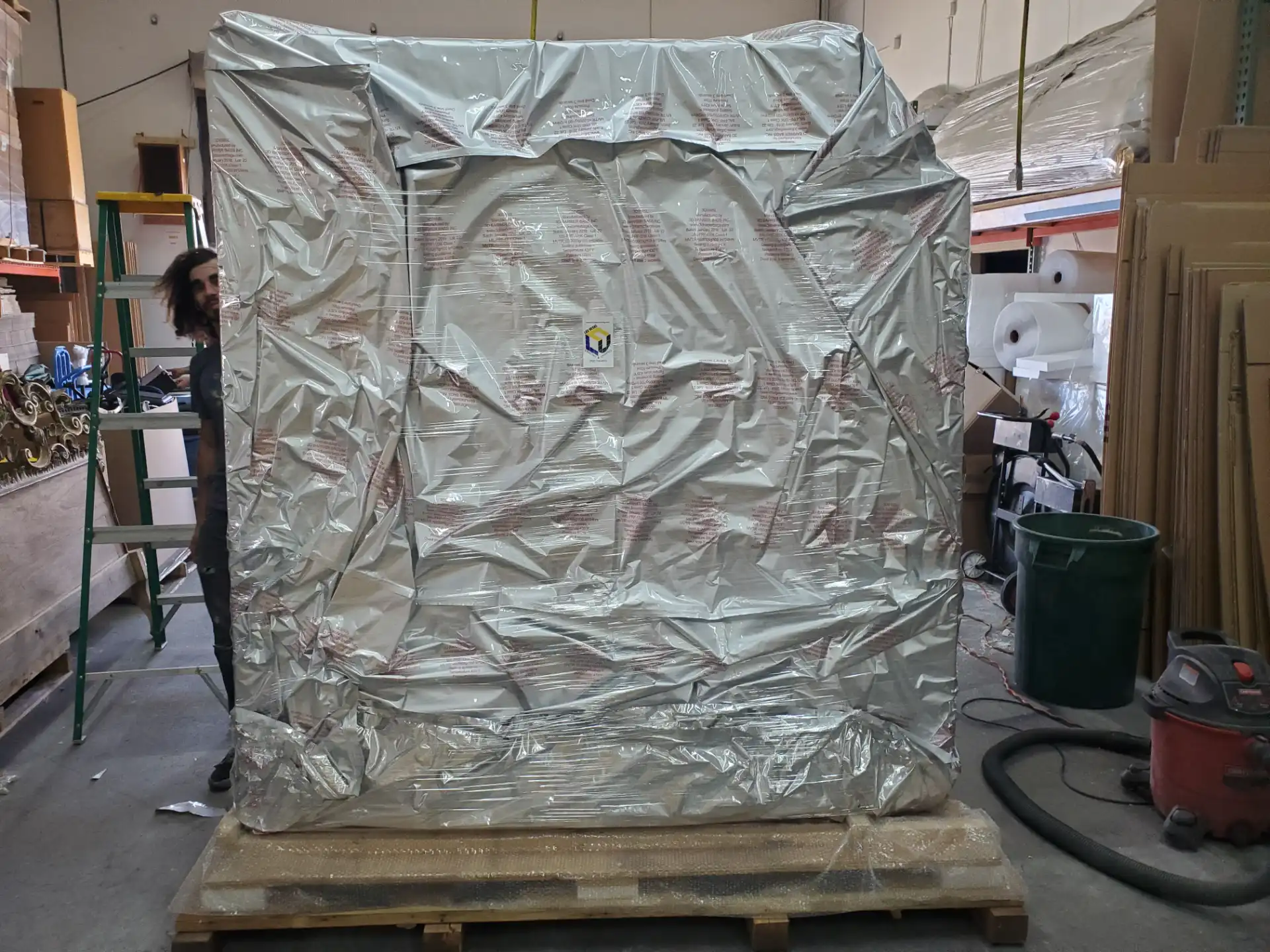 Vapor barrier wrapped crate staged in the warehouse